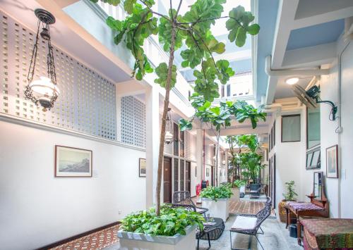 a corridor of a building with potted plants at Areca Hotel Penang in George Town