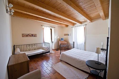 ファブリアーノにあるAntica Loggiaのベッドルーム1室(ベッド1台、ソファ、テーブル付)