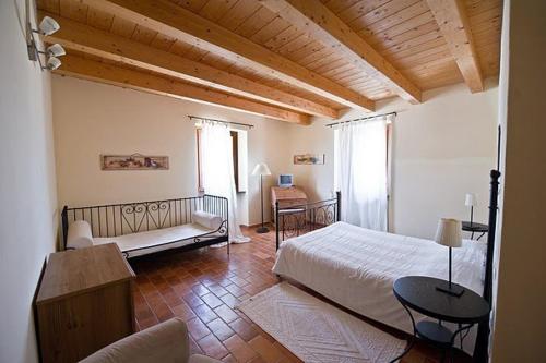 a bedroom with a bed and a couch and a table at Antica Loggia in Fabriano