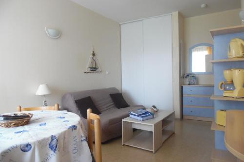 a living room with a couch and a table at appartement "Helios" touristes et curistes annonce d'un particulier in Rochefort