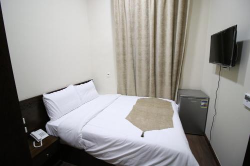 a hotel room with a bed with a towel on it at Miramar Talaat Harb Square in Cairo