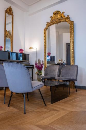 a room with two chairs and a mirror at Radisson Blu Hotel Schwarzer Bock Wiesbaden in Wiesbaden