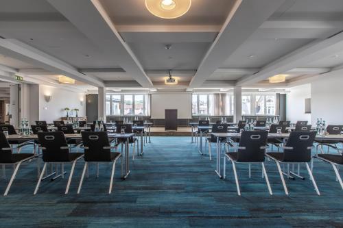 a banquet hall with tables and chairs in a room at Radisson Blu Hotel Schwarzer Bock Wiesbaden in Wiesbaden