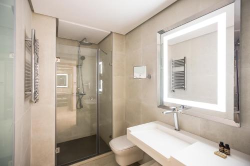 a bathroom with a sink and a shower at Aparthotel Adagio Premium Casablanca City Center in Casablanca