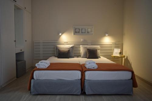 a bedroom with a large bed with two towels on it at Marini Apartments in Moraitika