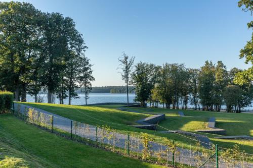 a golf course next to a body of water at Golden Lakes Hotel in Boussu-lez-Walcourt