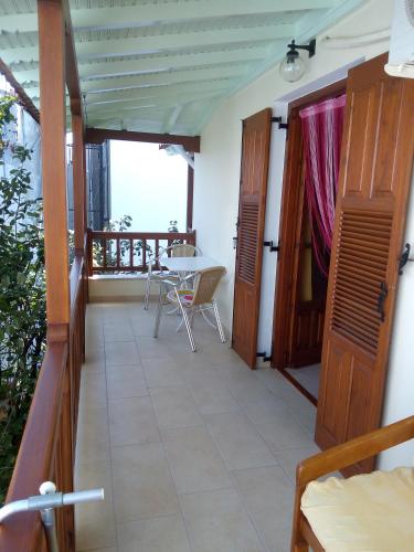 a room with a balcony with a table and chairs at Pansion Matoula in Skiathos Town