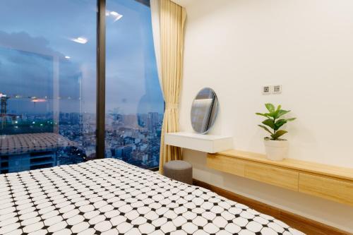a bedroom with a view of a city at Serviced Apartment in Metropolis near Lotte and Daewoo Hanoi in Hanoi
