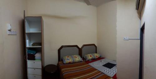 a small bedroom with a bed in a room at Jitra homestay in Jitra