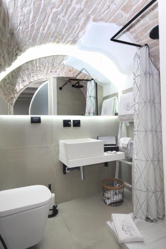 a bathroom with a white toilet and a sink at B&B da Tiffany in Terlizzi