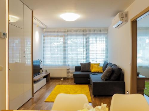 a living room with a couch and a tv at Apartman Delux Adda in Zagreb