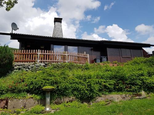 a house with a chimney and a wooden fence at Haus Ani Winterberg in Winterberg