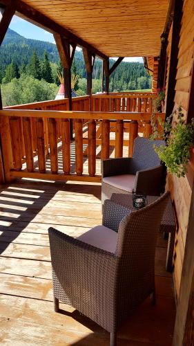 a patio with two chairs and a table on a deck at Ranč pod Ostrou Skalou in Stratená