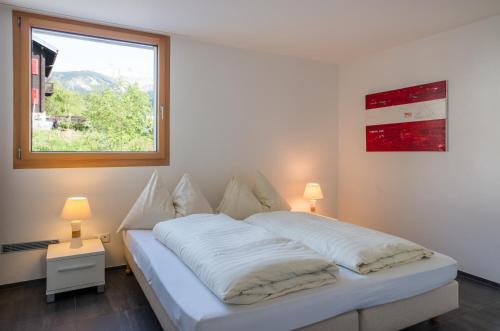 Ένα ή περισσότερα κρεβάτια σε δωμάτιο στο LAAX Homes Prada Biala