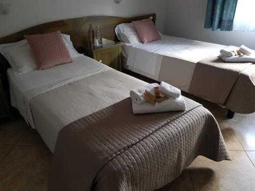A bed or beds in a room at Hotel Monte Sirai