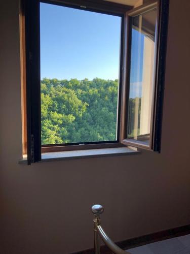 a window in a room with a view of trees at Le case di Nonna Gina in Capranica