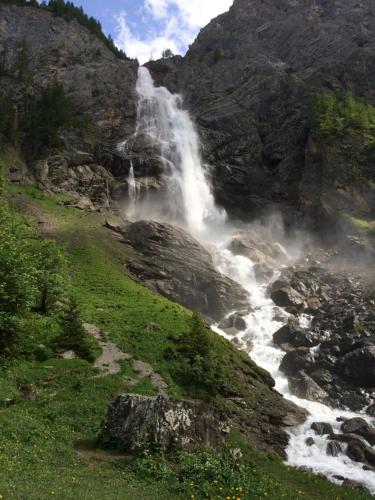 a waterfall on the side of a mountain at Chalet Aloa in Adelboden