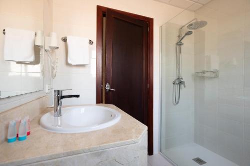 a bathroom with a sink and a shower at Hotel Gaya in Paguera