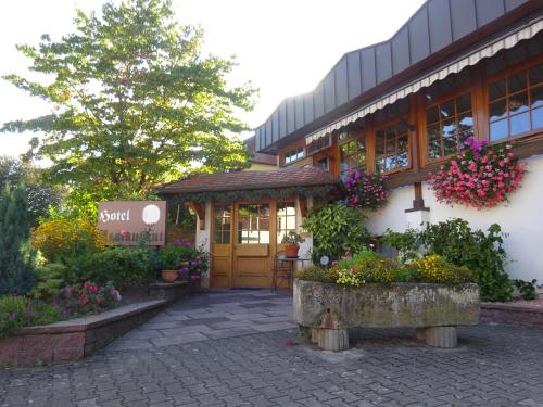 a building with flowers in front of it at Hotel Altenberg in Baden-Baden