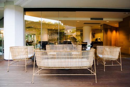 a group of chairs sitting in front of a store at Gran Hotel Victoria in Santander