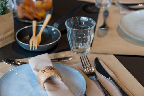 a table with a plate with a napkin and fork and knife at Hotel Mercure Toulouse Centre Compans in Toulouse