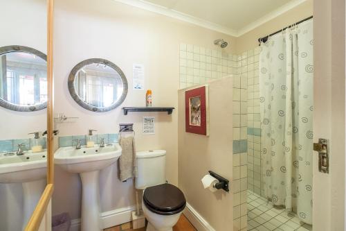 a bathroom with a toilet and a sink and a shower at Inn-Style in Cape Town
