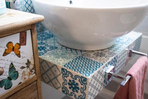 a bathroom with a sink and a bowl on a counter at 4sisters' Open Space in Aradeo