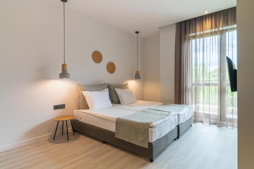 a bedroom with a large bed and a window at Primorski Hotel in St. St. Constantine and Helena