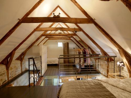 a bedroom in an attic with wooden beams at Moulin des Borderies in Singles