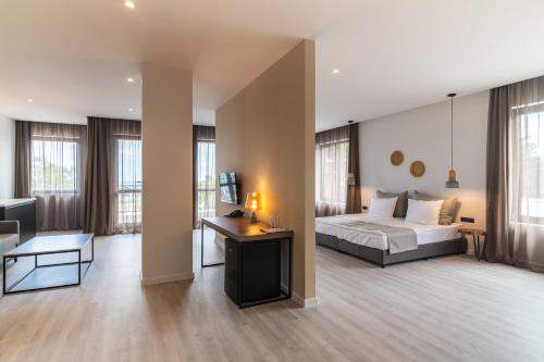 a bedroom with a bed and a desk in a room at Primorski Hotel in St. St. Constantine and Helena