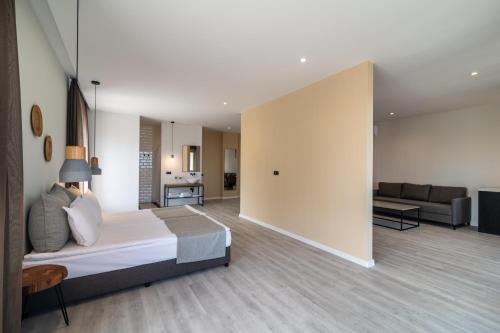 a bedroom with a bed and a living room at Primorski Hotel in St. St. Constantine and Helena