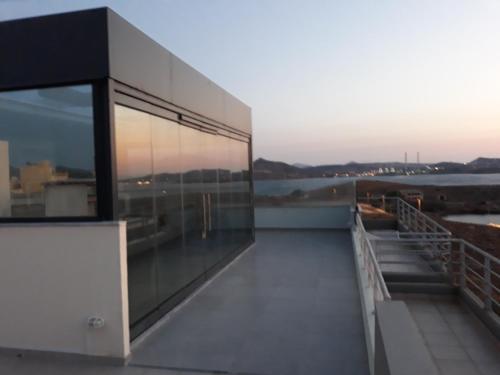 a building with a view of the water at deep blue in Lávrion