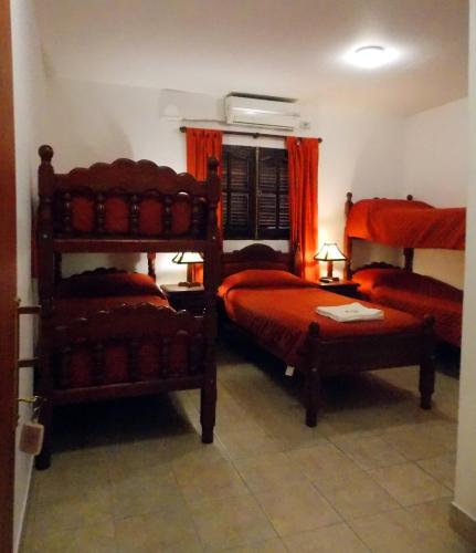 a bedroom with two bunk beds and a chair at Portal De Los Valles in Chicoana