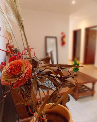 a vase with a flower on top of a table at Portal De Los Valles in Chicoana