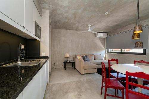 a kitchen and living room with a table and a couch at N1 Hostel Apartments and Suites in Santarém