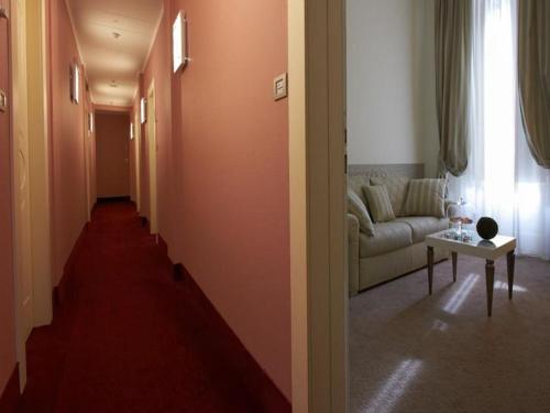 a living room with a couch and a table at JR Hotels Oriente Bari in Bari