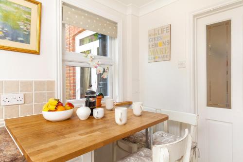 a kitchen with a table with a bowl of fruit on it at 79 Tower in Winchester