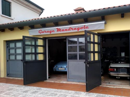 a garage with a car garage manufacturer sign on it at Le Mandragole B&B in Roncade