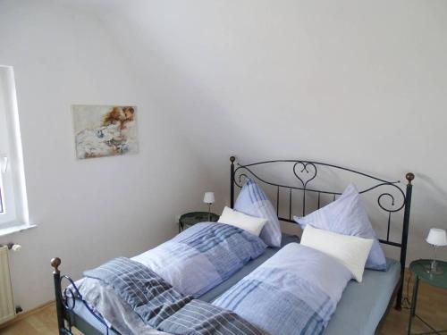 a bedroom with two beds with blue and white pillows at Helle Ferienwohnung in Nettetal bei Venlo in Nettetal