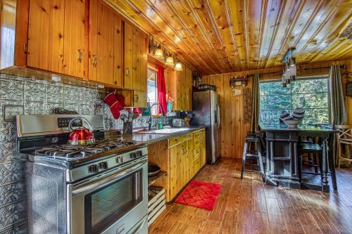 a kitchen with wooden cabinets and a stove at Whispering Pines in Leavenworth