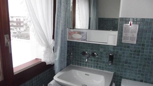 a bathroom with a sink and a toilet and a mirror at Minster Hotel in Unteriberg