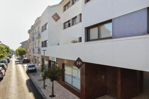 a building on a street with cars parked on the street at N1 Hostel Apartments and Suites in Santarém