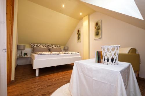 a bedroom with a bed and a table with books at Ferienhaus Holzer in Egg am Faaker See