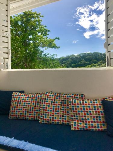 two pillows sitting on a balcony with a window at Oleadas Maderas in San Juan del Sur
