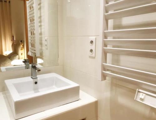 a white bathroom with a sink and a staircase at Villa la Grande Bastide piscine et tennis collectif in Cassis