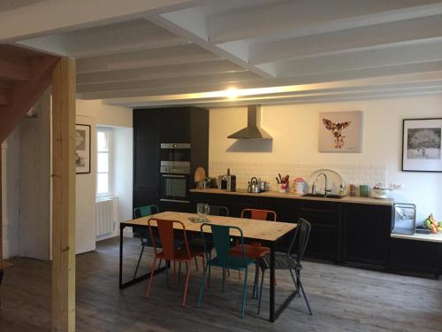 格魯瓦的住宿－Maison familiale Groix，厨房以及带桌椅的用餐室。