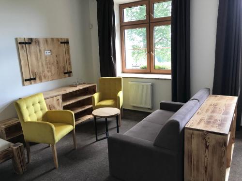 a living room with a couch and chairs and a table at Bezručova škola in Staré Hamry
