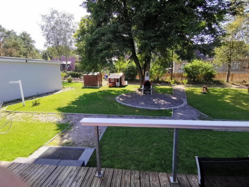 a backyard with a fire pit and a tree at Bungalows am Grimnitzsee in Joachimsthal