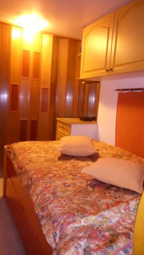 a bedroom with a bed with two pillows on it at Villa George - Family Holidays in Nea Makri