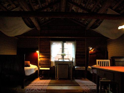 a bedroom with a bed and a window and a table at Wiborggården Bed and Breakfast in Boda